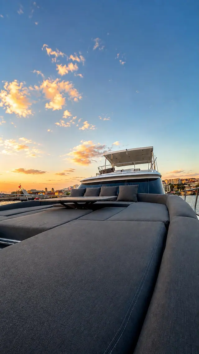 The foredeck sun bed facing a dramatic sunset sky